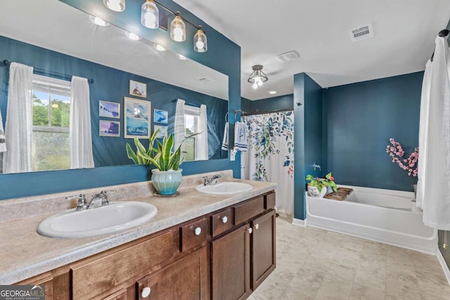 bathroom featuring vanity and a tub