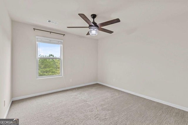 carpeted spare room with ceiling fan