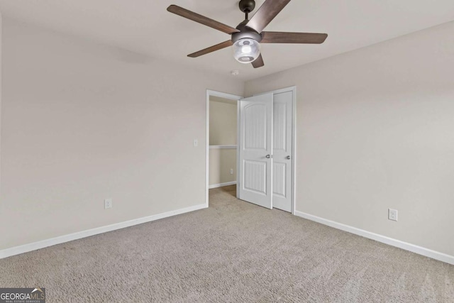 unfurnished bedroom with light colored carpet and ceiling fan