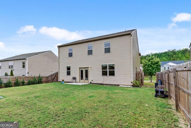 back of property with a patio area and a lawn