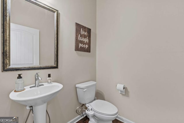 bathroom featuring toilet and sink