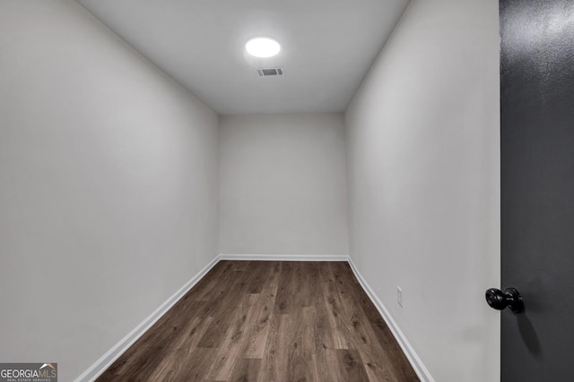 unfurnished room with dark hardwood / wood-style flooring