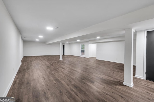 basement with dark hardwood / wood-style floors