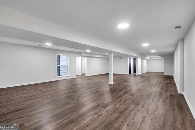 basement featuring dark hardwood / wood-style flooring