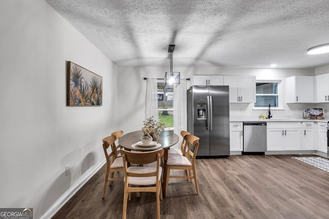 dining area featuring light wood-type flooring and sink