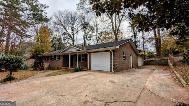 single story home featuring a porch and a garage