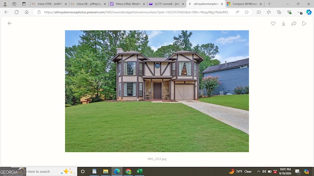 view of front of house with a front yard and a garage