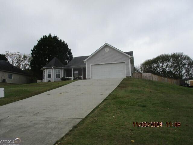 view of front of property with a front yard and a garage