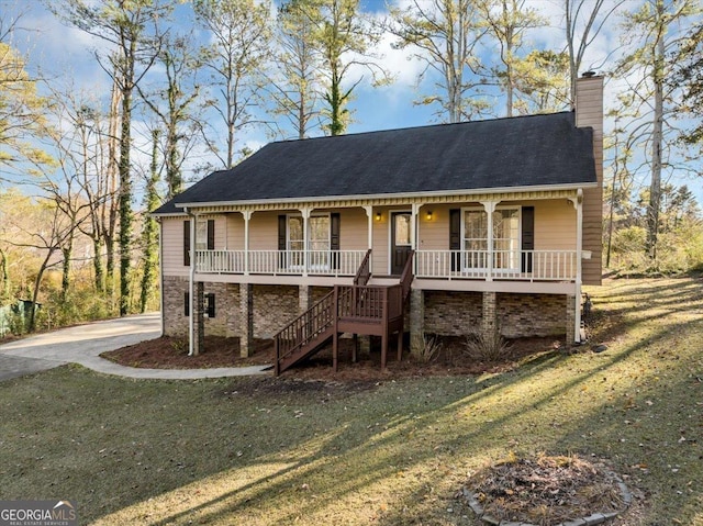 view of front of home with covered porch and a front yard