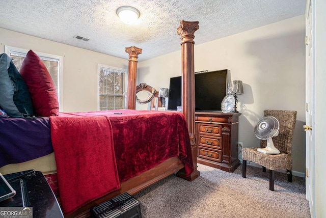 bedroom with carpet flooring and a textured ceiling