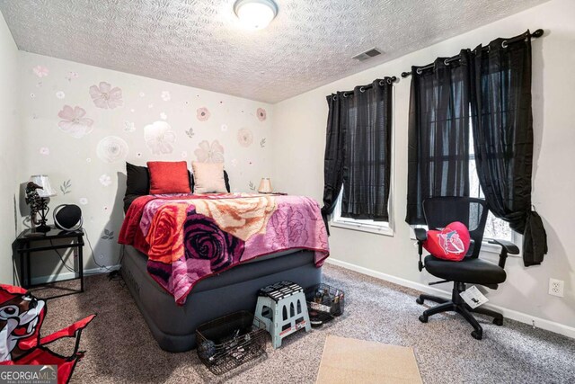 bedroom with carpet flooring and a textured ceiling