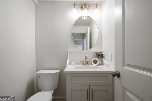 bathroom featuring vanity and toilet