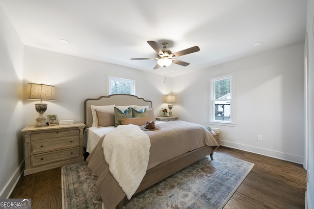 bedroom with dark hardwood / wood-style flooring and ceiling fan