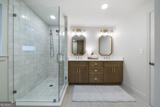 bathroom with vanity and a shower with shower door