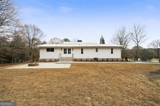 view of front facade with a fire pit and a patio