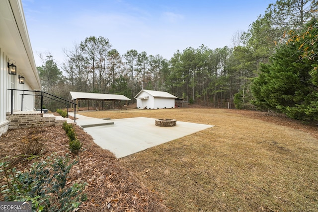 view of yard featuring an outbuilding and an outdoor fire pit