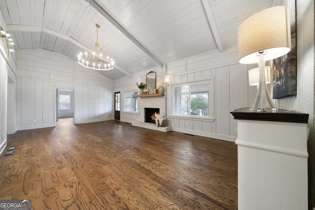 unfurnished living room featuring wooden ceiling, lofted ceiling with beams, dark hardwood / wood-style floors, a chandelier, and a fireplace