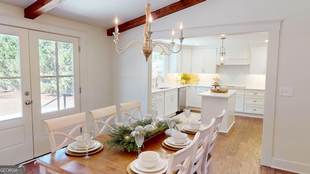 dining room featuring french doors, beamed ceiling, and light wood-type flooring