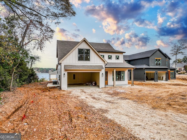 view of front of home with cooling unit and a garage