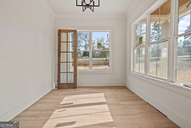 unfurnished sunroom with a chandelier