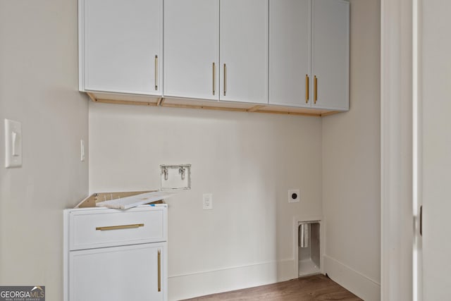 laundry area featuring electric dryer hookup, cabinets, washer hookup, and hardwood / wood-style flooring