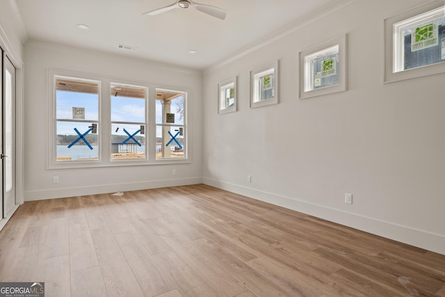 unfurnished room featuring ceiling fan, ornamental molding, and light wood-type flooring