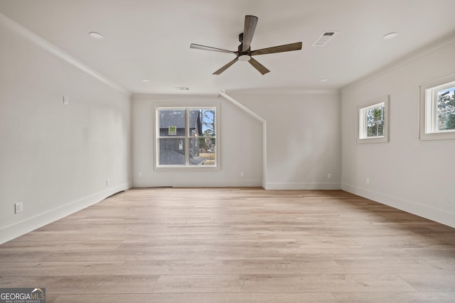 spare room featuring light wood-type flooring, ceiling fan, and ornamental molding