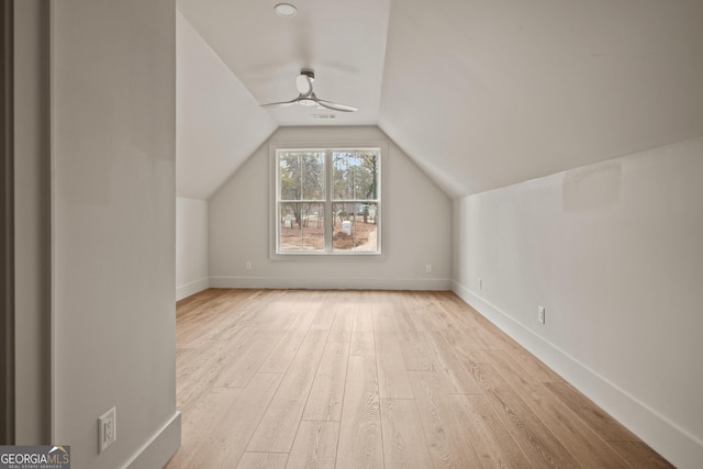 additional living space featuring ceiling fan, light wood-type flooring, and lofted ceiling