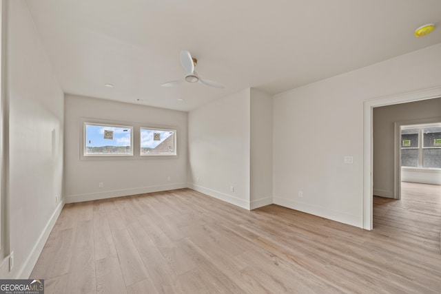 unfurnished room with ceiling fan, plenty of natural light, and light hardwood / wood-style floors