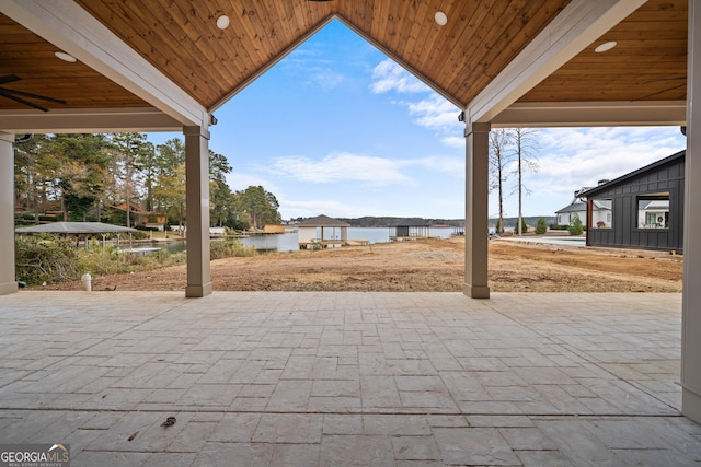 view of patio / terrace featuring a water view and ceiling fan