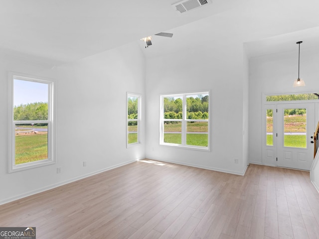 1215 White Oak Way, Griffin, GA 30224 - empty room with plenty of natural light, light wood-style flooring, baseboards, and a towering ceiling