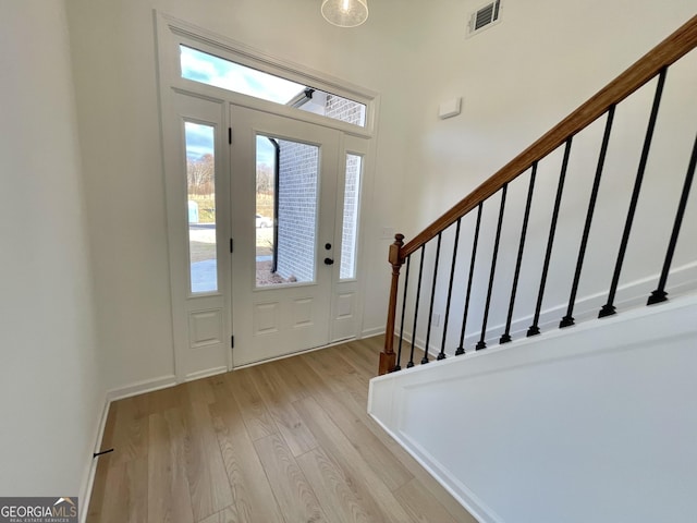 foyer with light hardwood / wood-style floors