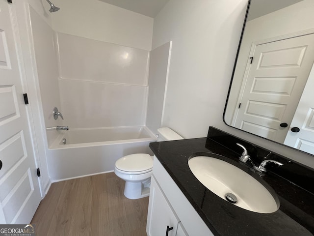 full bathroom featuring hardwood / wood-style flooring, vanity, toilet, and shower / bathing tub combination