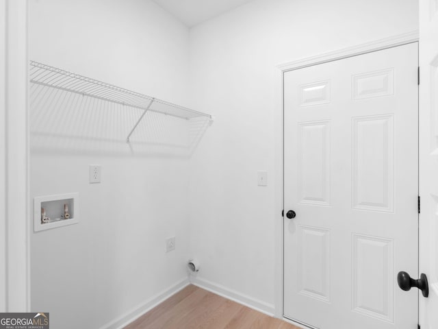 1215 White Oak Way, Griffin, GA 30224 - laundry area with hookup for a washing machine, electric dryer hookup, light wood-style floors, and baseboards