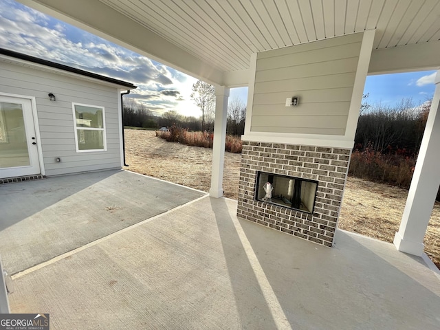 view of patio / terrace with an outdoor brick fireplace