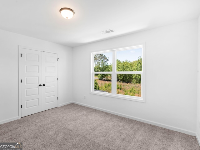 1215 White Oak Way, Griffin, GA 30224 - unfurnished bedroom with carpet flooring, baseboards, and a closet