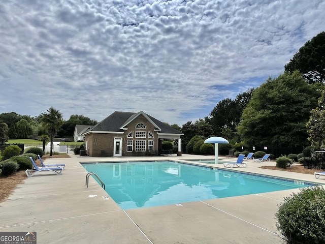 1215 White Oak Way, Griffin, GA 30224 - community pool featuring a patio area, an outdoor structure, and view of wooded area