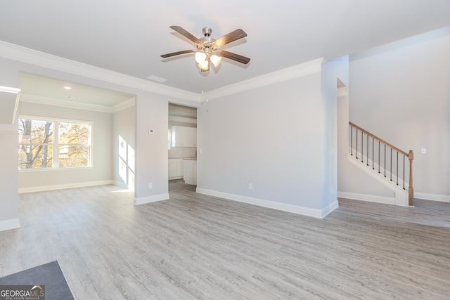 unfurnished living room featuring ceiling fan, light wood-type flooring, and crown molding