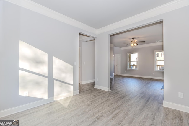 spare room featuring ceiling fan, ornamental molding, and light hardwood / wood-style flooring