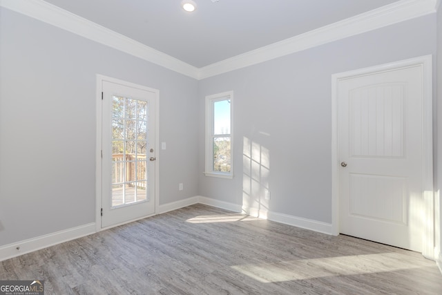 unfurnished room with light wood-type flooring and crown molding