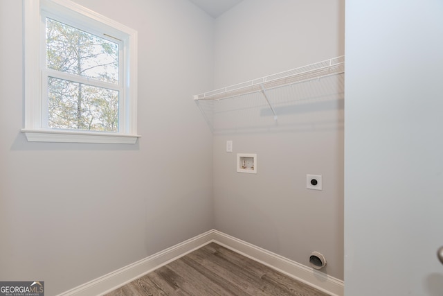 laundry room featuring hookup for a washing machine, electric dryer hookup, and hardwood / wood-style floors