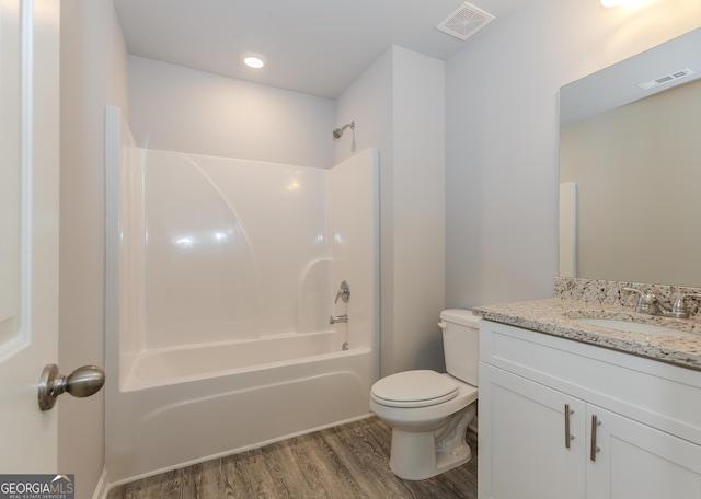 full bathroom with vanity, toilet, wood-type flooring, and tub / shower combination