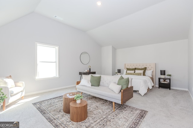 carpeted bedroom with lofted ceiling and baseboards