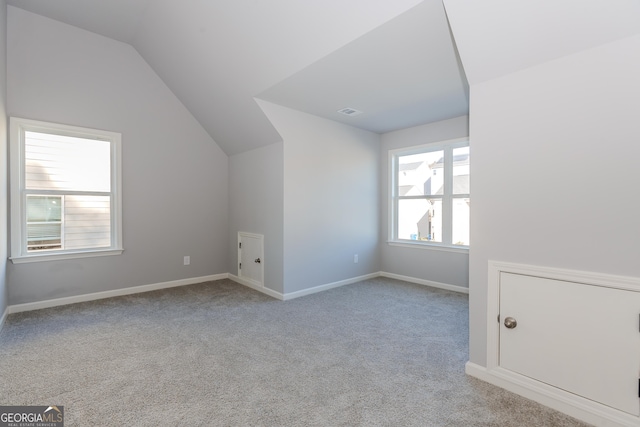 bonus room featuring light carpet and lofted ceiling