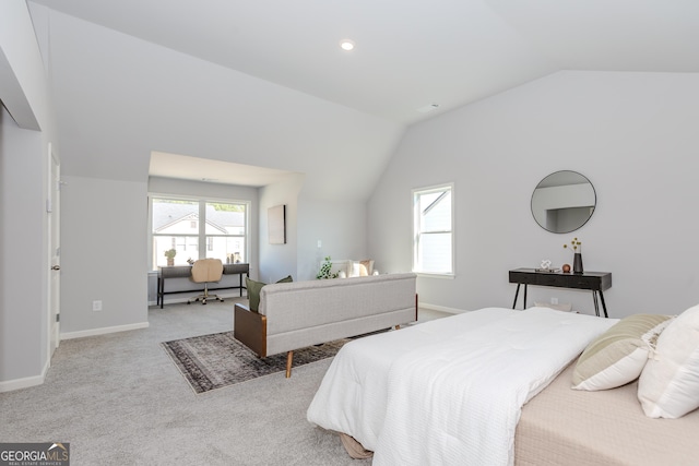 carpeted bedroom with lofted ceiling and baseboards