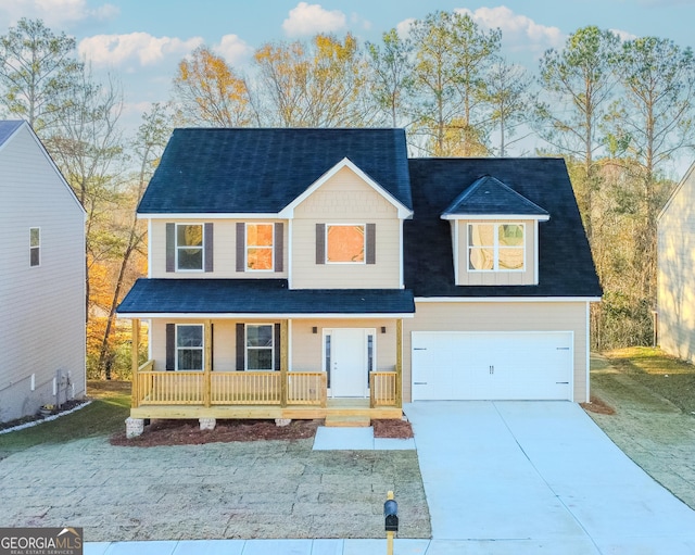 view of front of home with a front lawn, covered porch, and a garage