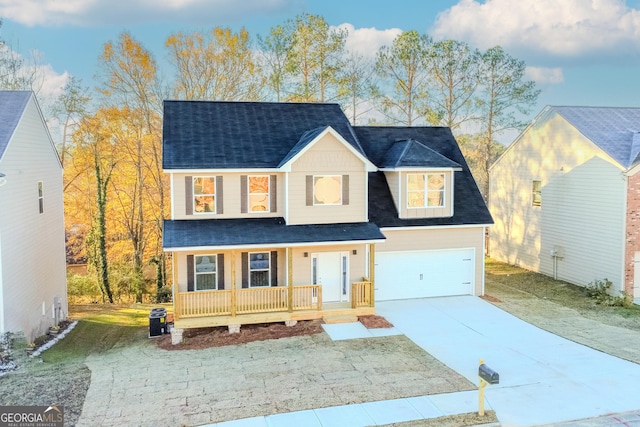 view of front of property with covered porch and a garage