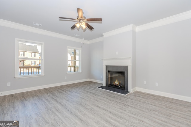 unfurnished living room featuring ceiling fan, crown molding, and light hardwood / wood-style flooring