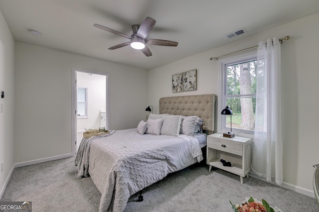 carpeted bedroom featuring connected bathroom and ceiling fan