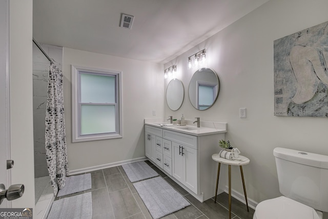 bathroom featuring vanity, toilet, and walk in shower